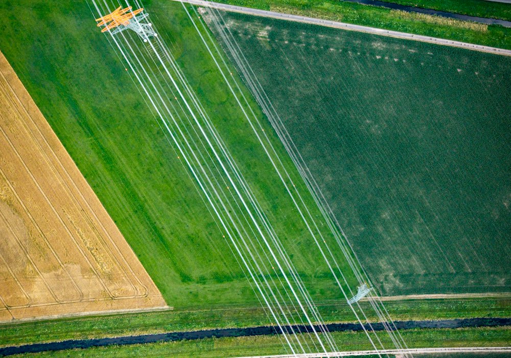 Aerial view of transmission lines crossing farmland